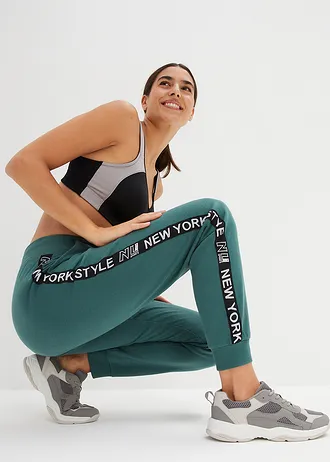 Spodnie dresowe ze ściągaczami i napisem z boku nogawek • zielony matowy z nadrukiem • sklep bonprix